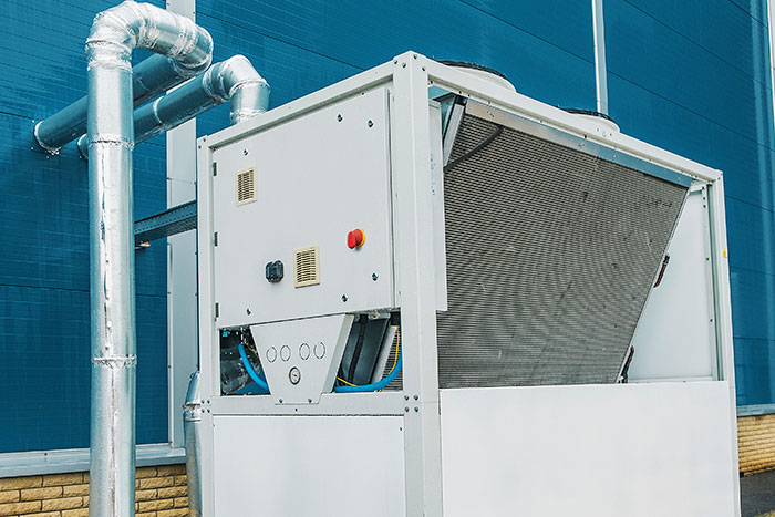 older chiller for hvac system on top of commercial roof